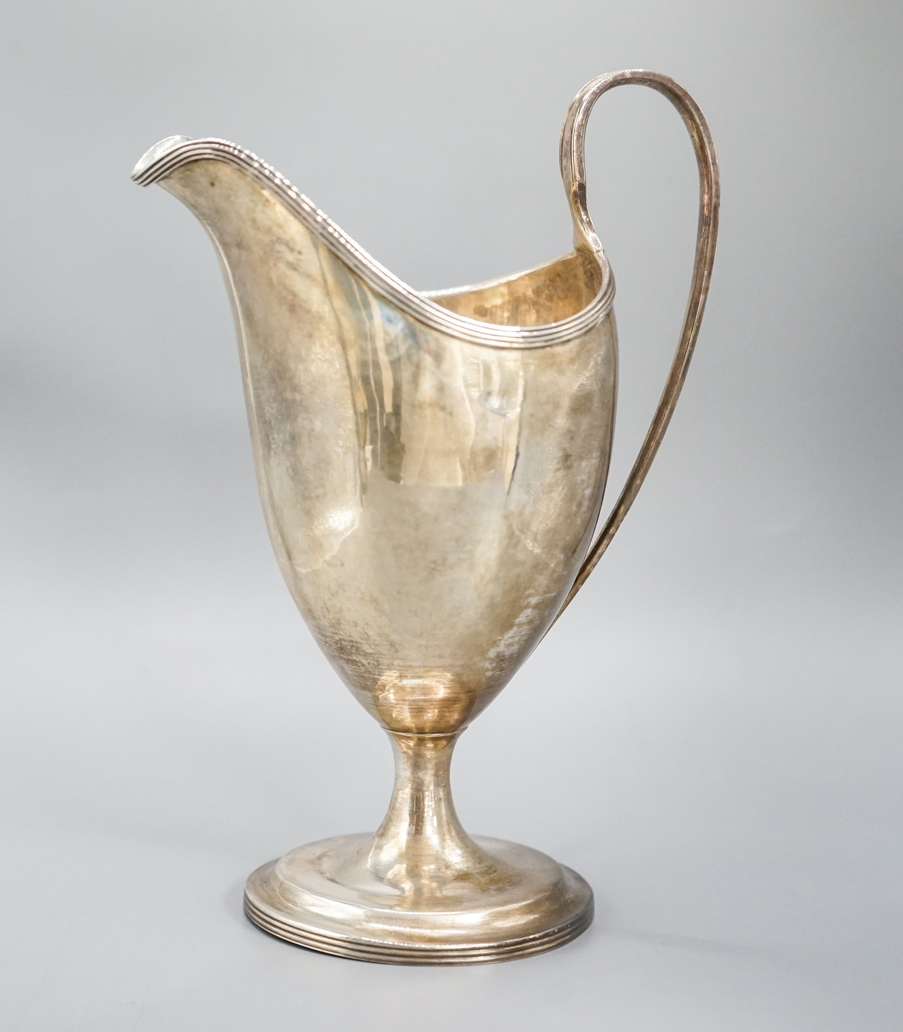 A George III Irish silver pedestal cream jug, George West, Dublin, 1794, 18cm, 7oz.